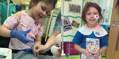 Millie with her teddy bear helping her understand the feeding tube she needed